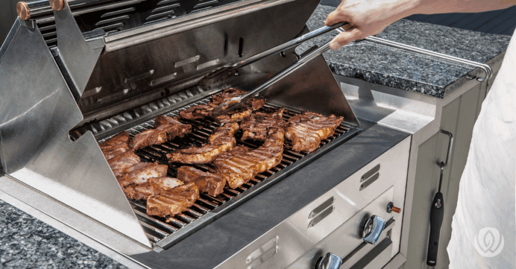 Close-up of burgers cooking on a stainless steel grill