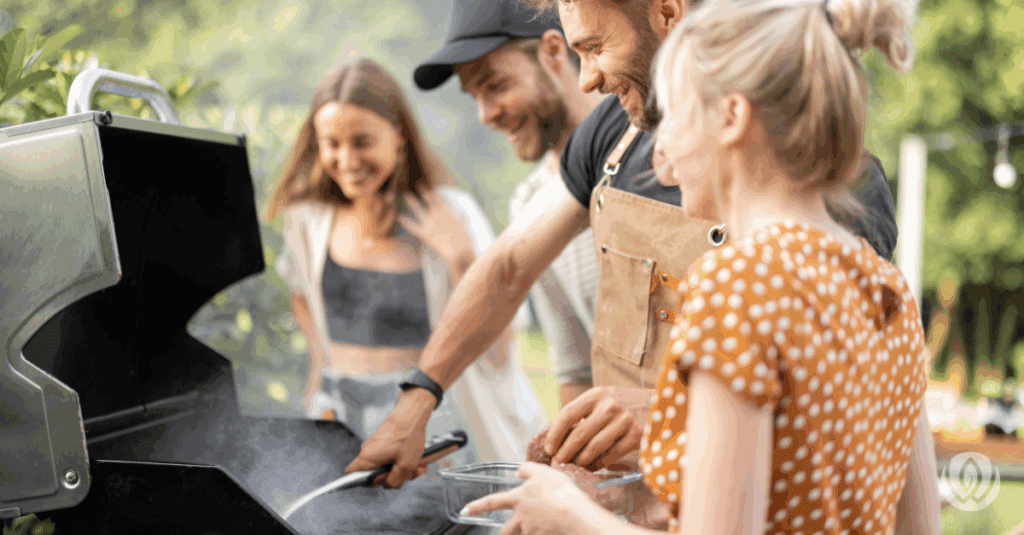 Family cooking together at a backyard grill station