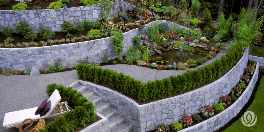 Tiered stone wall supporting elevated garden beds and outdoor furniture